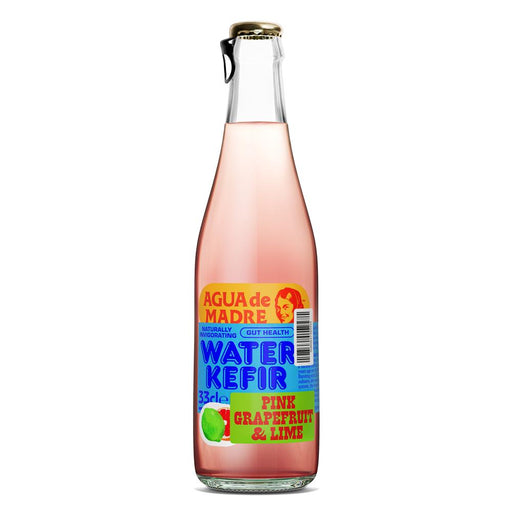 Pink grapefruit and lime kefir beverage in a clear glass bottle by Agua de Madre, featuring vibrant, colorful label design.