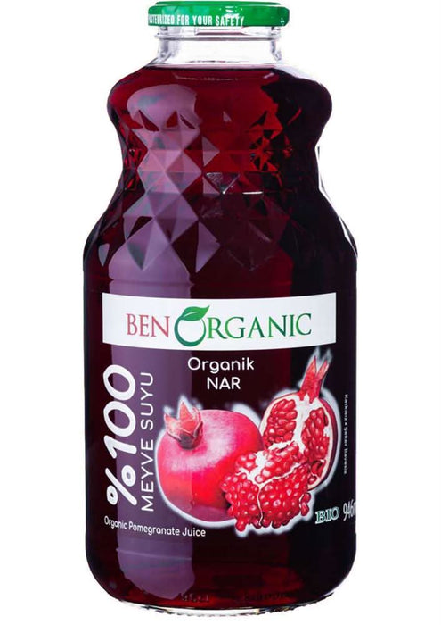 organic pomegranate juice in a clear glass bottle with a green cap and illustration of pomegranate fruit.