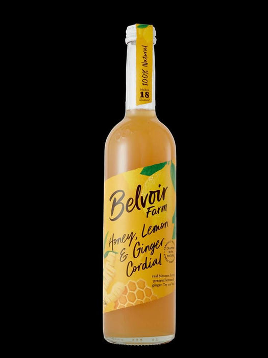 Belvoir Honey Lemon Ginger Cordial in a clear bottle with a yellow label featuring honeycomb and fruit illustrations.