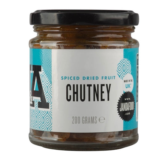 Janda Dried Fruit Chutney 200g jar with fruit pieces and wooden spoon on a rustic table