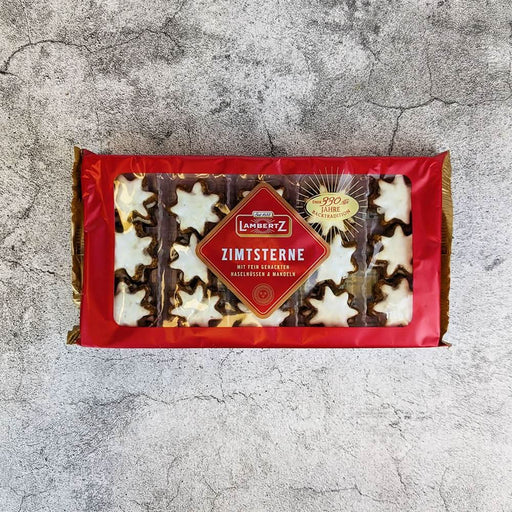 Lambertz Zimsterne Christmas cookies in star shape with white icing, packaged in a red box.