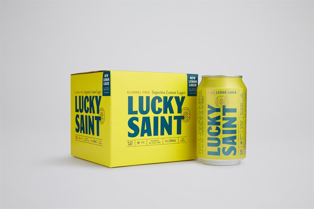 Four cans of Lucky Saint Lemon Lager, 330ml, featuring a bright yellow design.